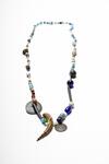 Necklace with beads, claw, shells, buttons, and a Haitian coin